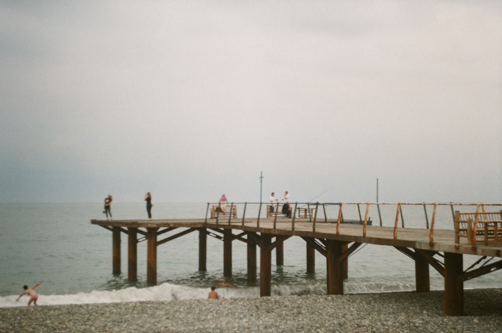 person standing on brown wooden dock during daytime