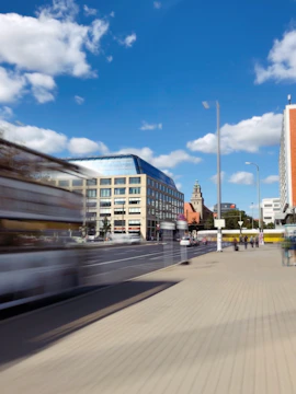 Commercial office building with glass front and busy street view.