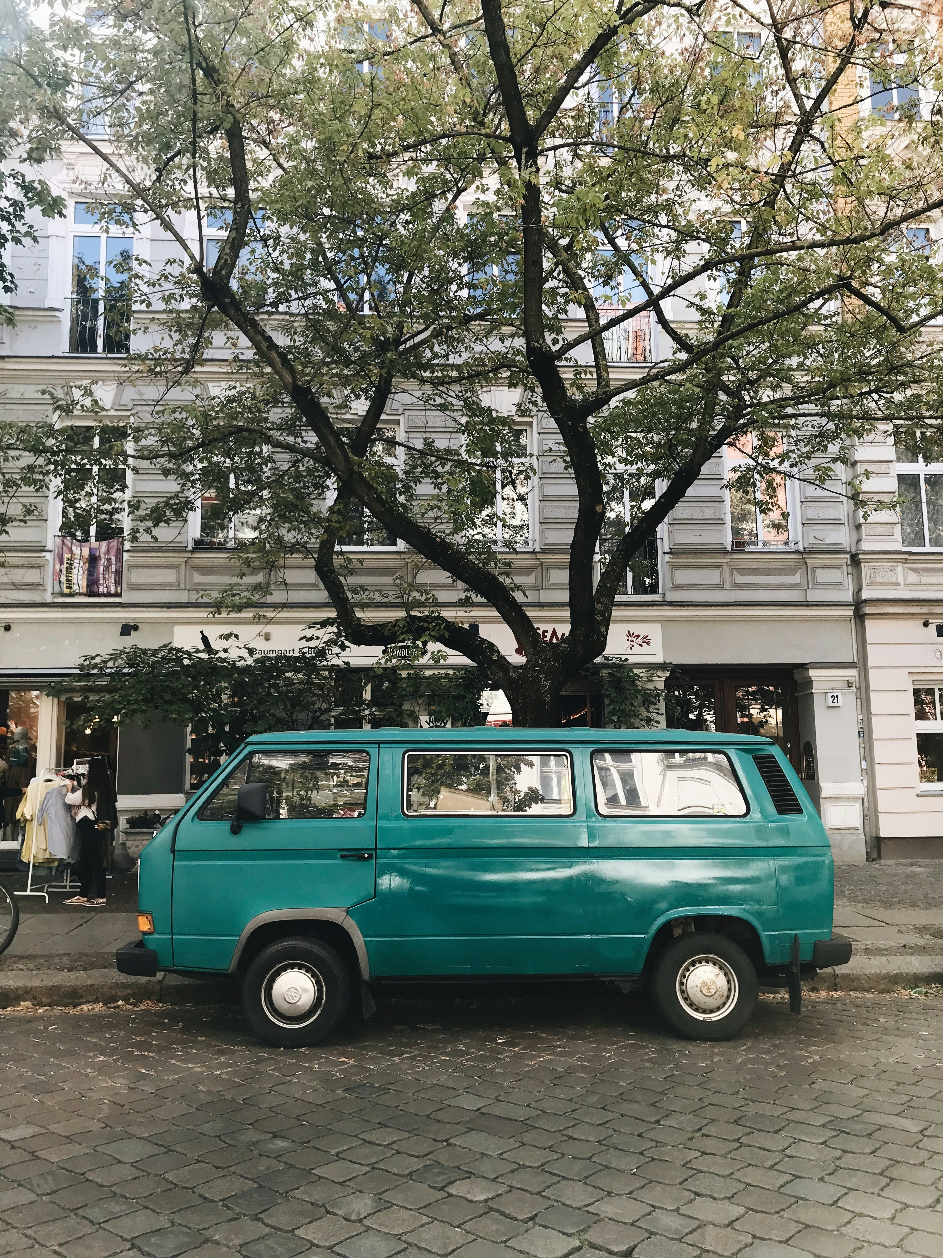 Green van parked under a tree photo – Free Human Image on Unsplash
