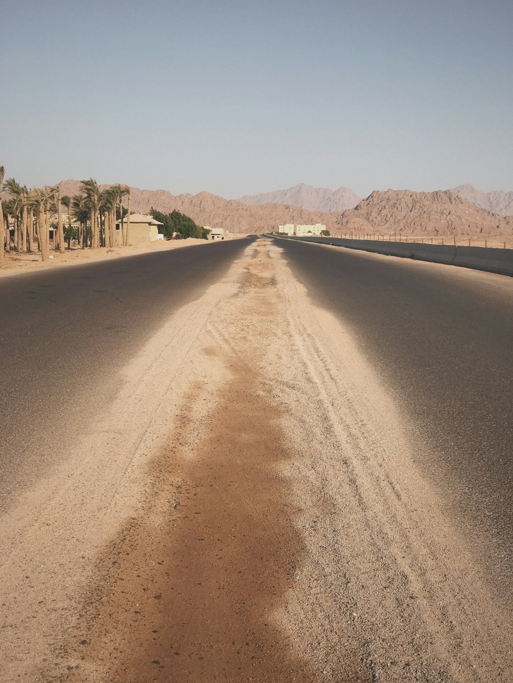 an empty road in the middle of the desert