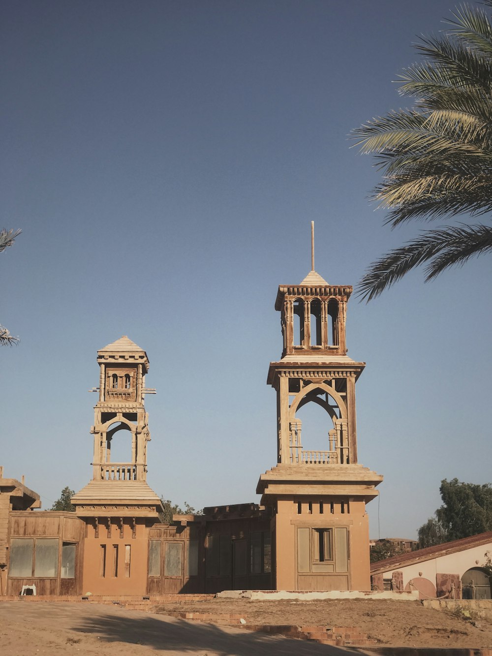 two brown concrete bell towers