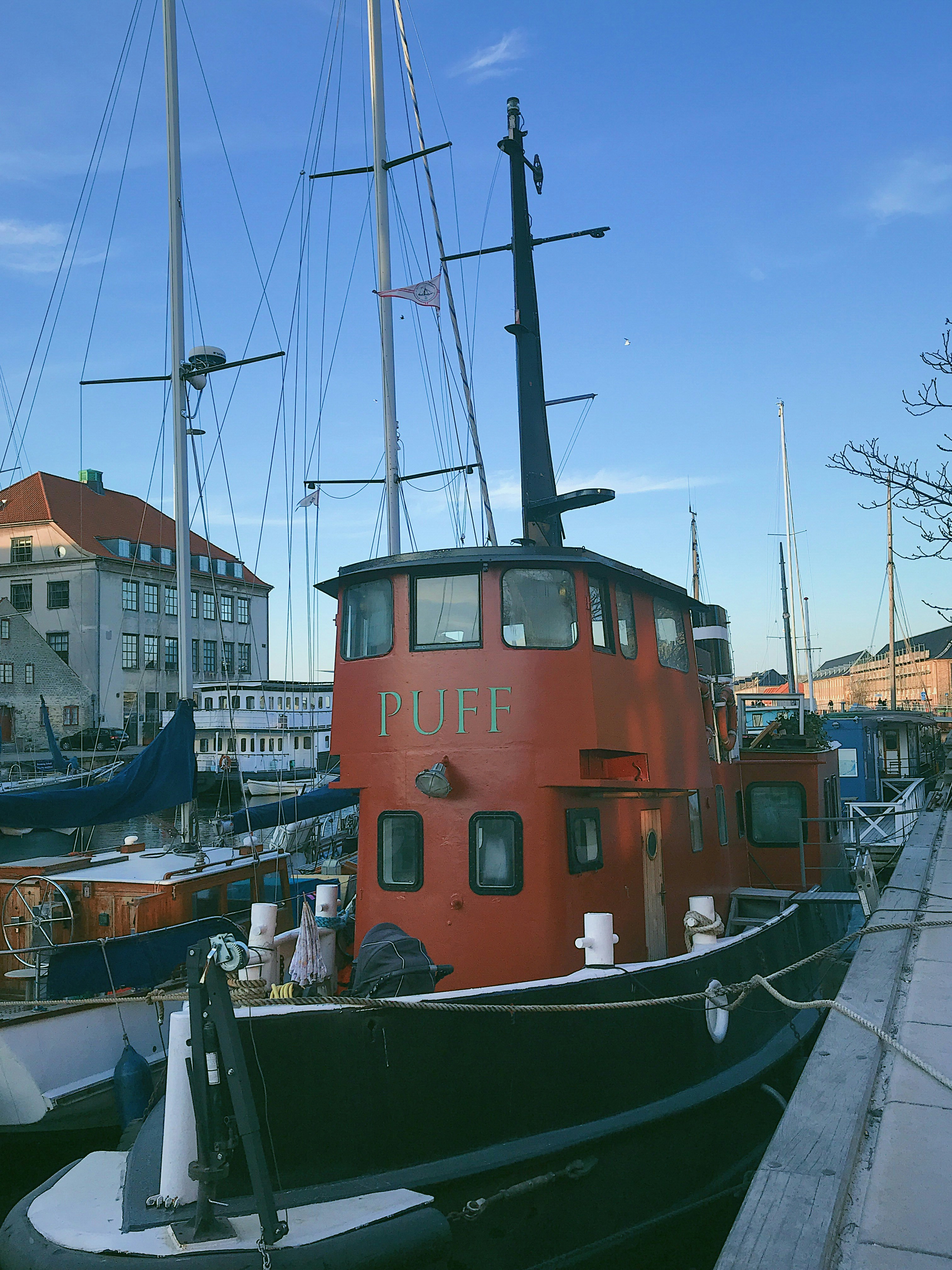 red and black boat near dock photo – Free Blue Image on Unsplash