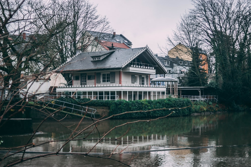 white house near body of water