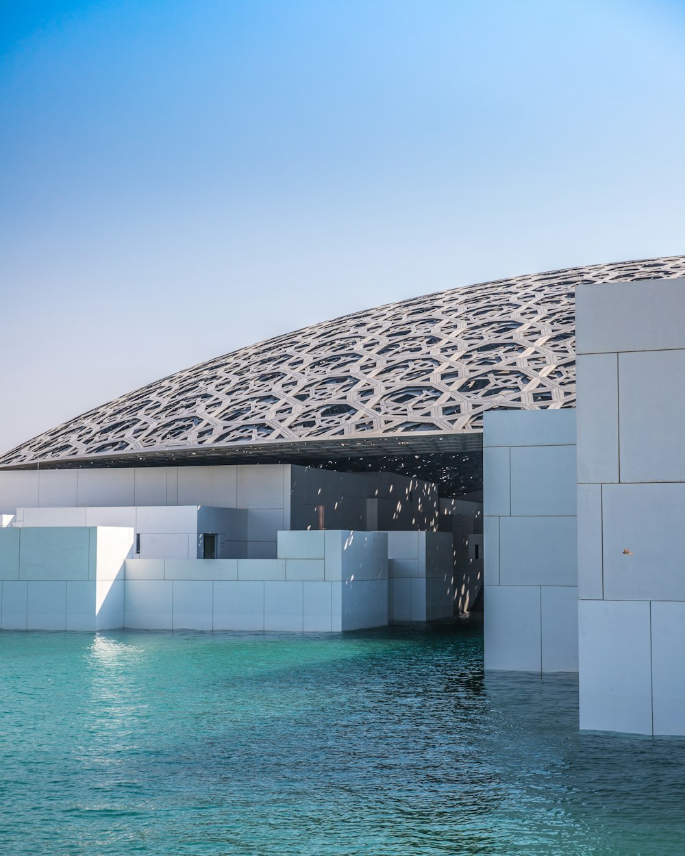 white concrete building beside blue beach