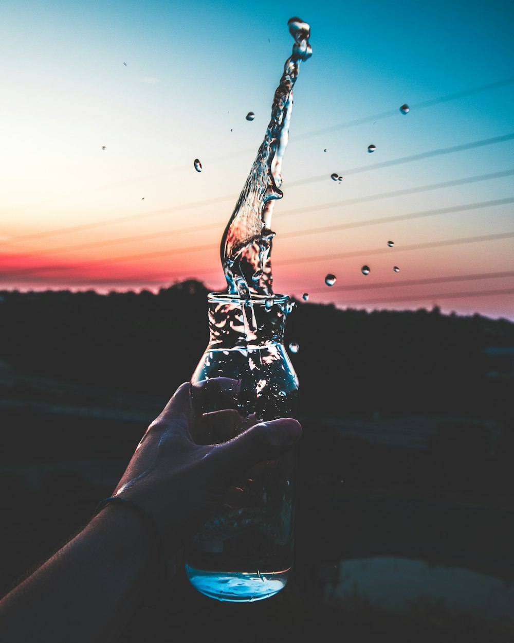 clear glass bottle with water