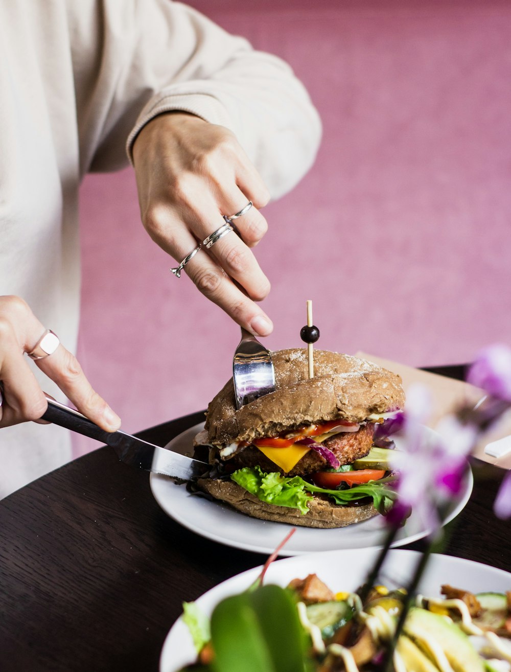 person slicing sandwich