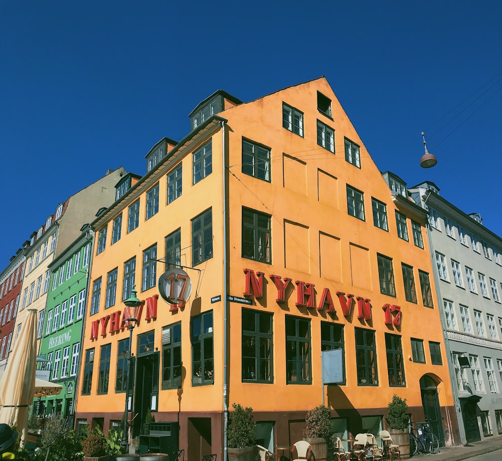yellow and green Nyhavn 17 building under a calm blue sky during daytime