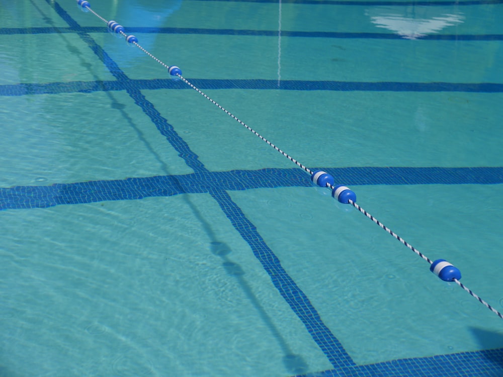 a close up of a swimming pool with a rope