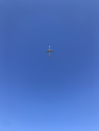 gray airplane flying during daytime