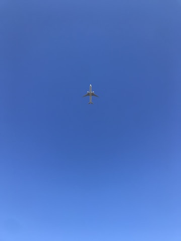gray airplane flying during daytime