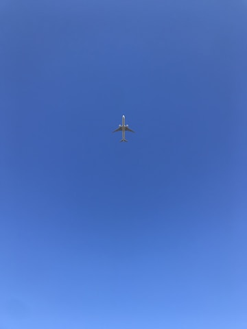 gray airplane flying during daytime