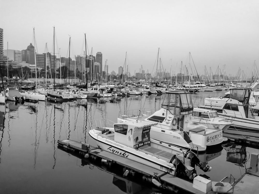 grayscale photo of boats on body of water during daytime