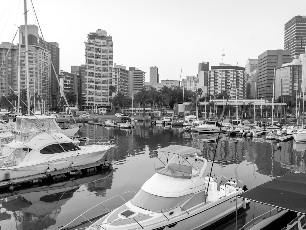 greyscale photo of yacht on seaport