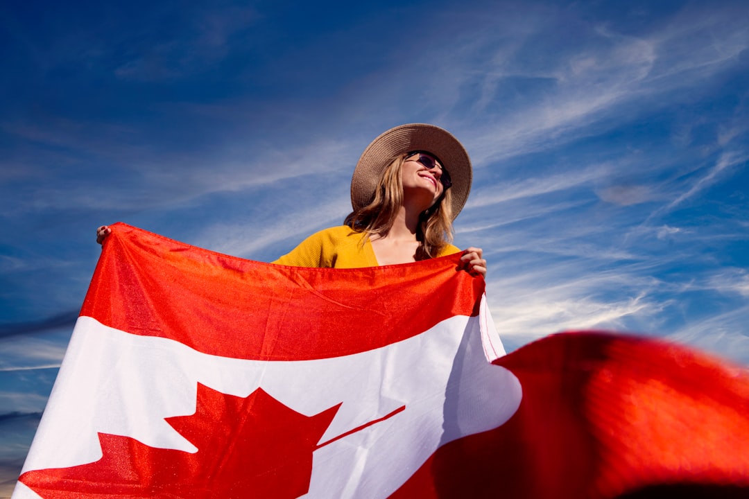 woman holding flag of Canada