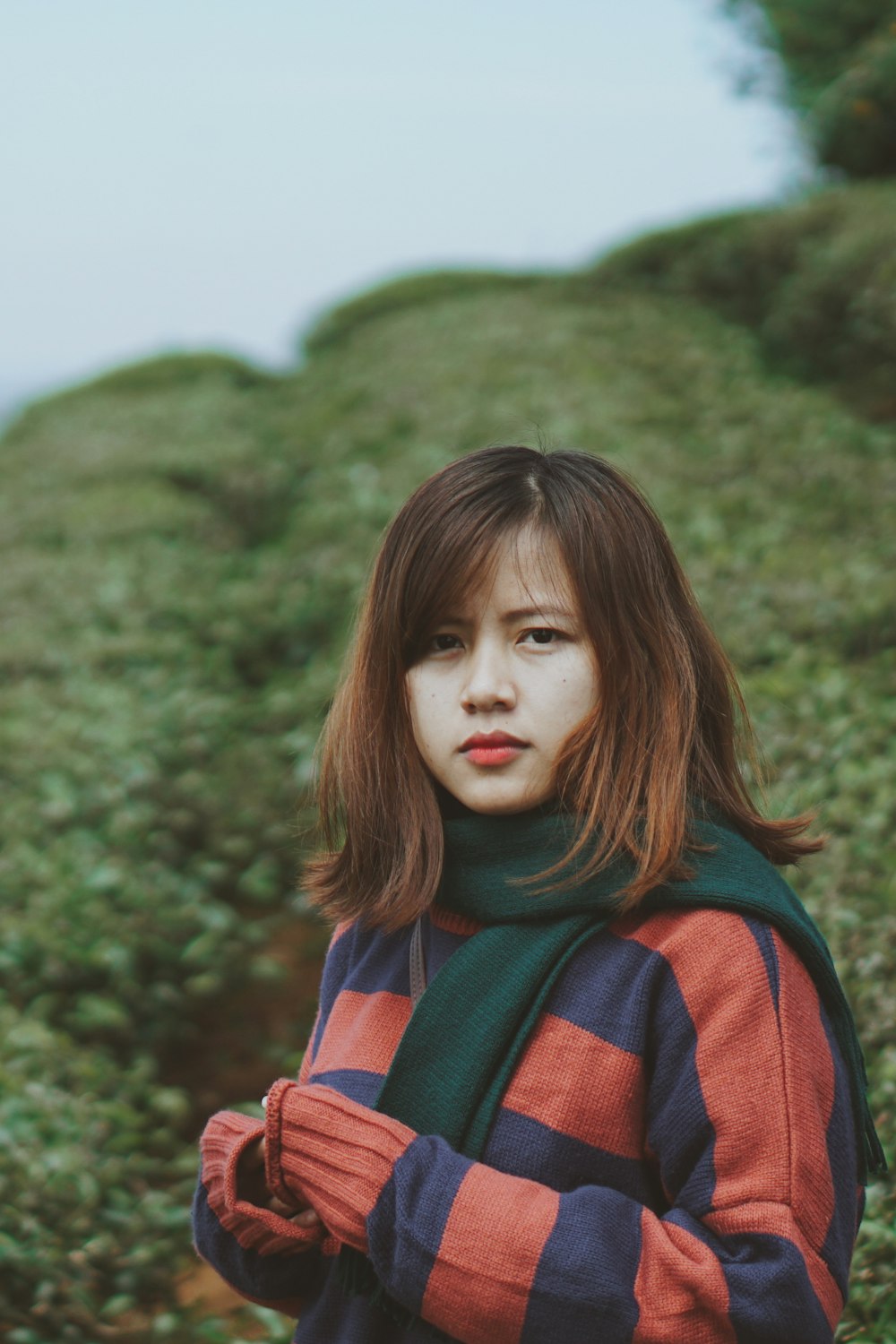 woman standing surrounded with plants at daytime