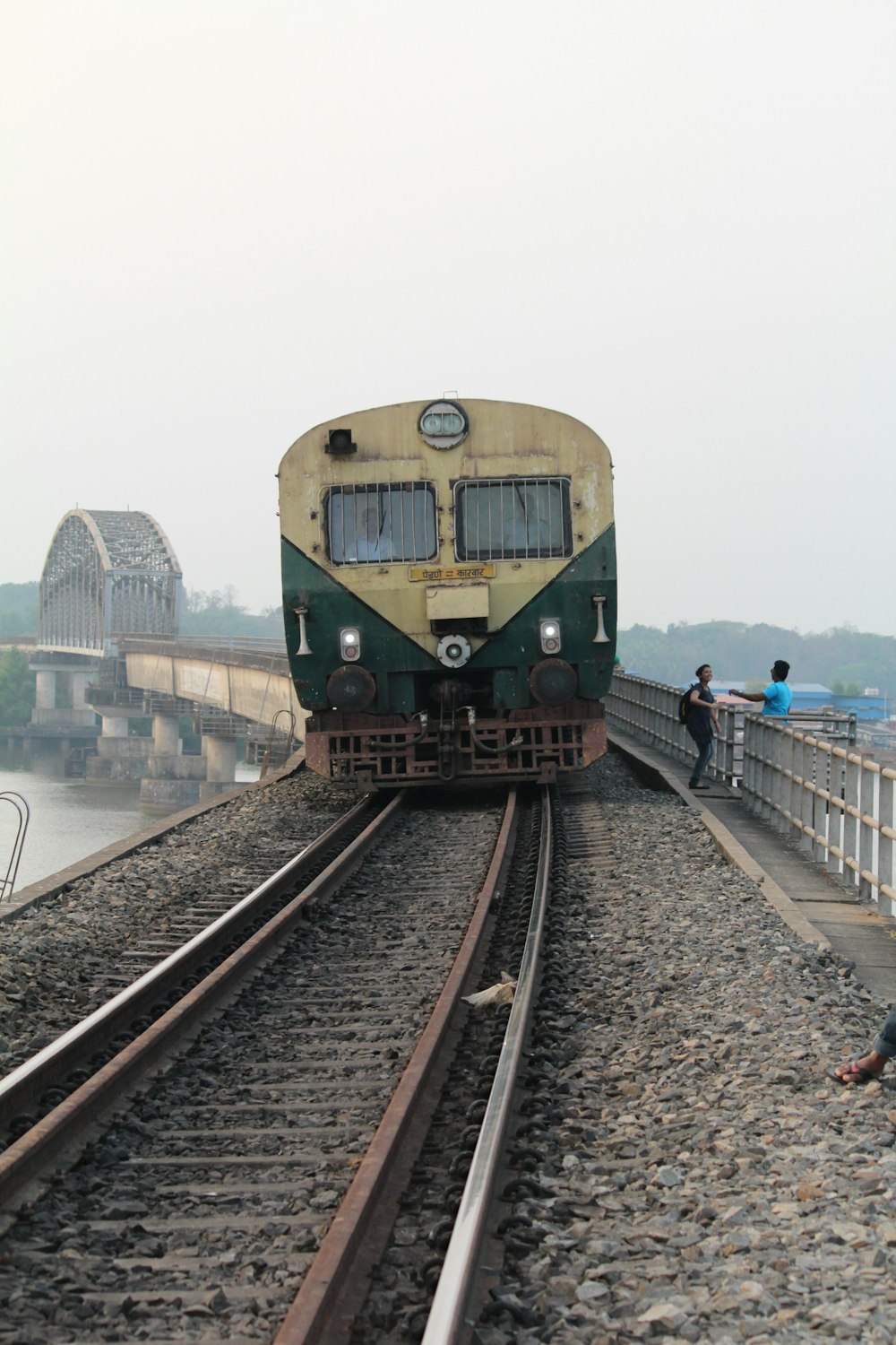 woman standing beside railway