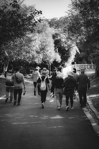 A diverse group of everyday people enjoying a peaceful outdoor walk together in warm, calming light.