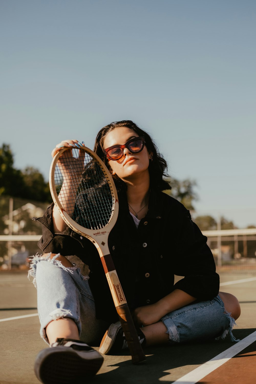 woman sitting and holding squash racket