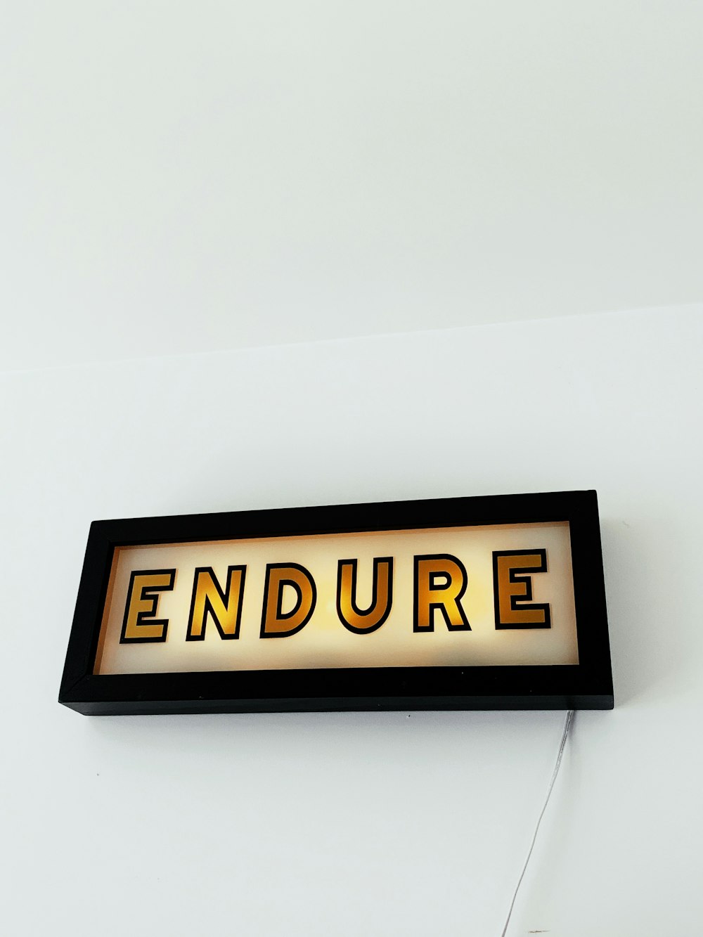 yellow Endure neon signage