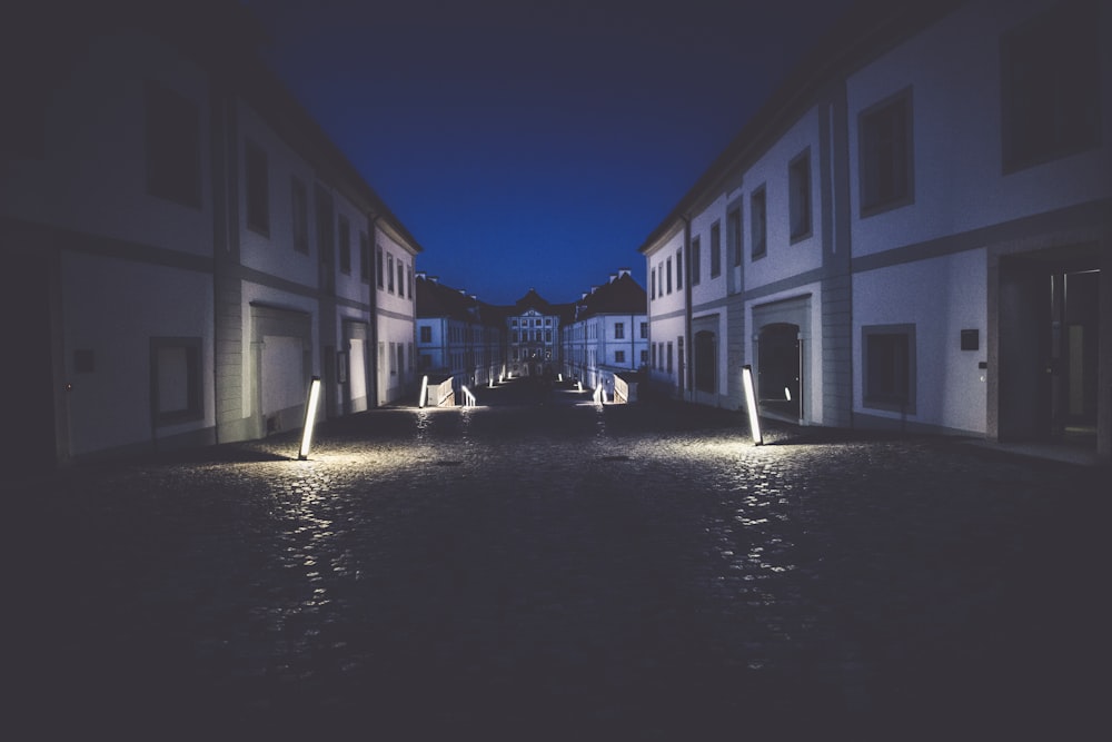 white concrete buildings between canal