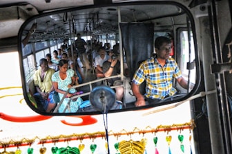 A tempo traveller bus filled with happy travelers.