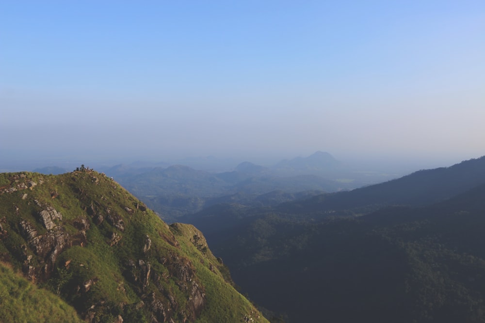 high-angle photography of mountains under clear blue sky