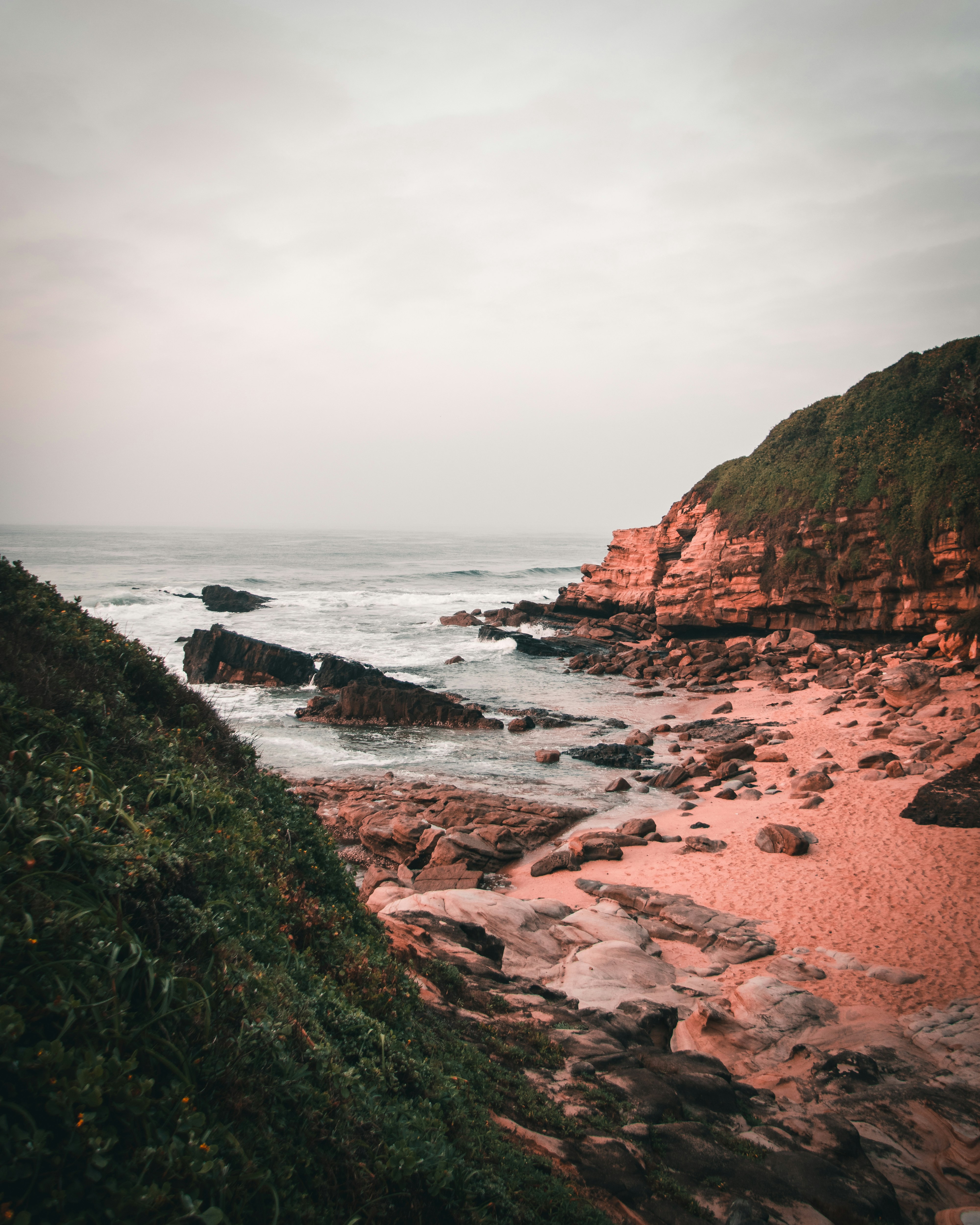 rocky and sand seashore during day