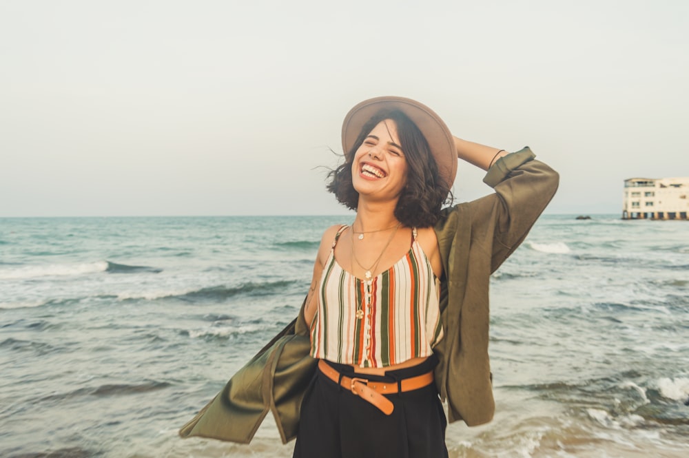 smiling woman standing on seashore