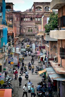 people on street between buildings