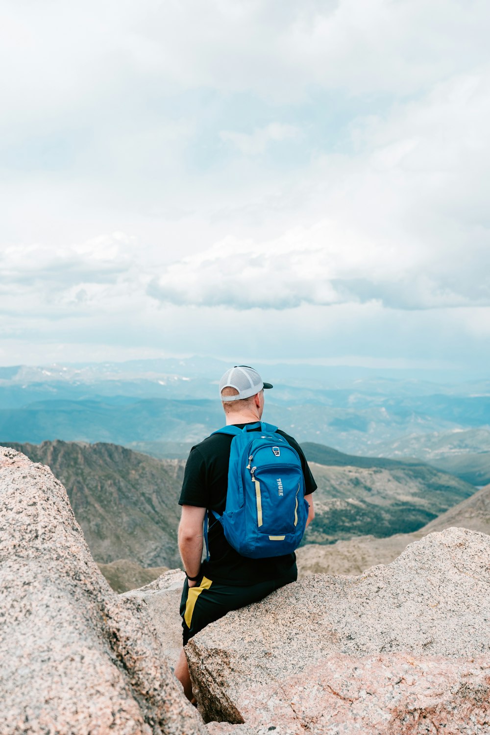 man standing on peak at daytime