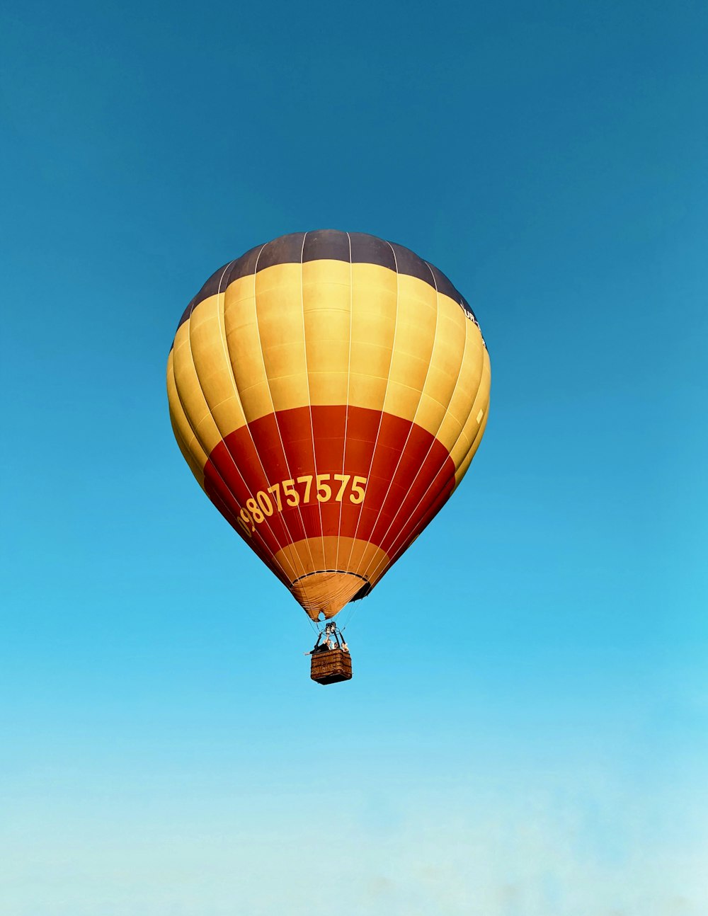 gray, yellow, and red hit air balloon during daytime