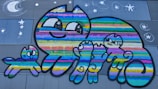 A group of smiling children and adults gathered around a colorful mural featuring playful cats.