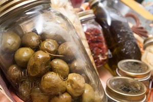 A close-up of traditional Lebanese pantry items like thyme and pickles.