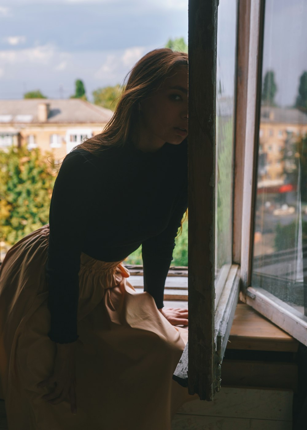 woman sitting on window