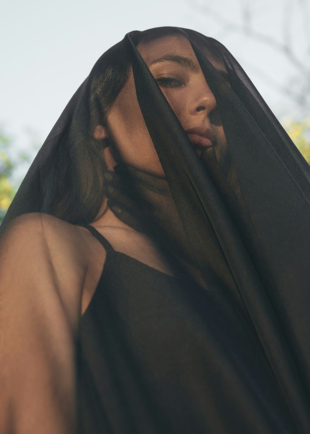 low angle photo of woman wearing black mesh viel