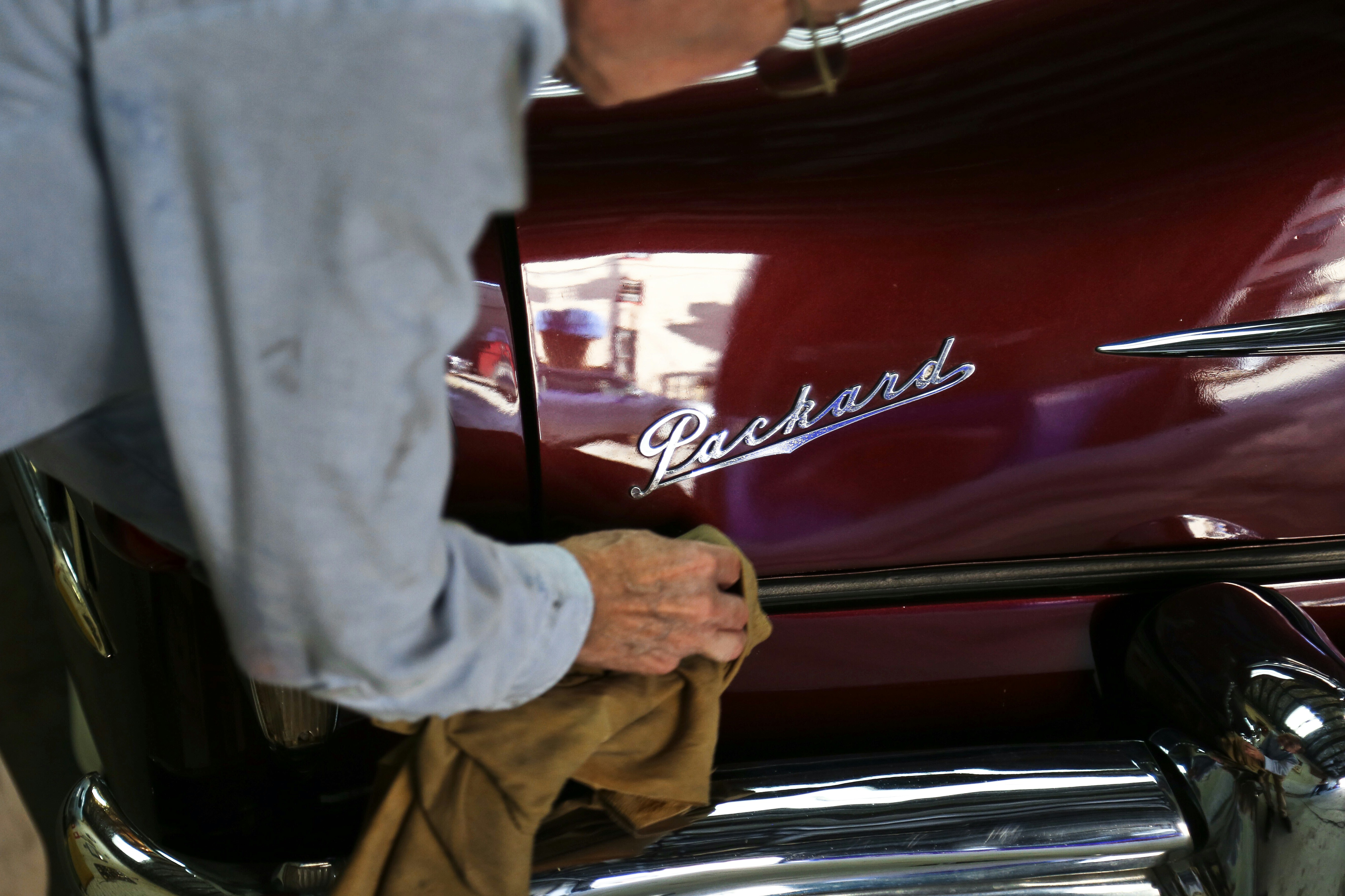 person wiping black rod