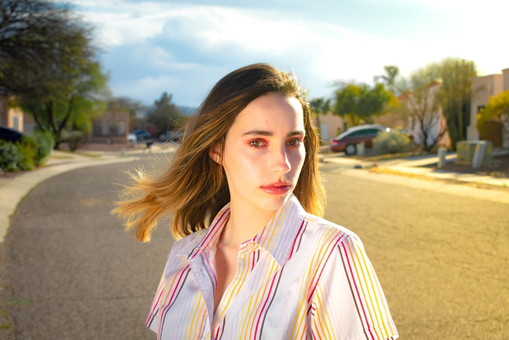 woman wearing white and pink striped collared blouse