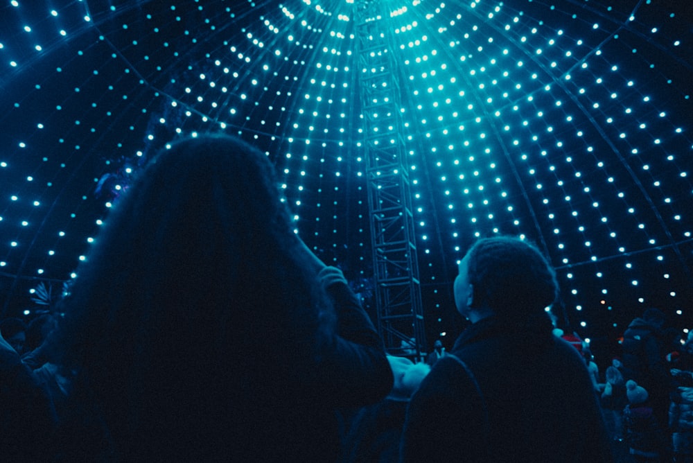 a group of people standing in front of a stage