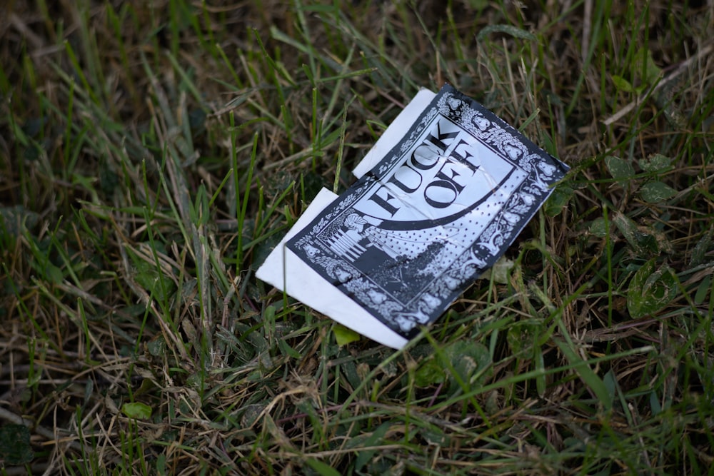 white and grey printer paper on grass