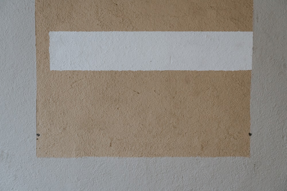 a white and brown painting on a wall