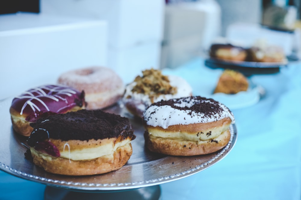 doughnuts on grey stainless steel cupcake stands