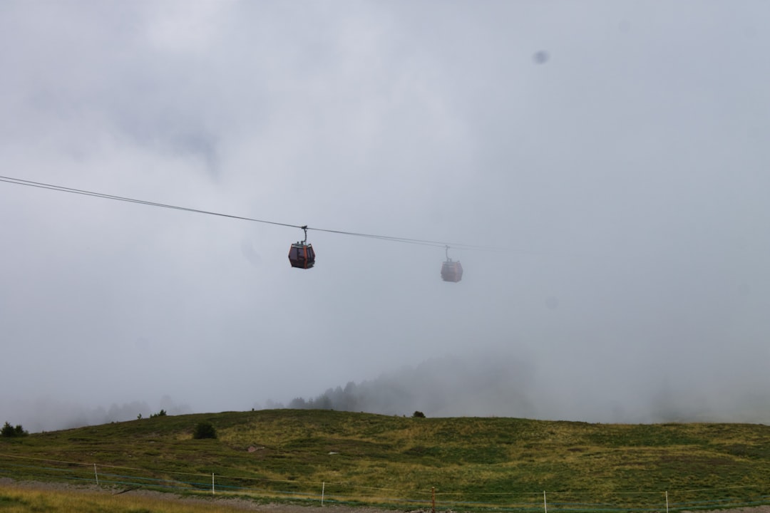 black cable cars covered in clouds