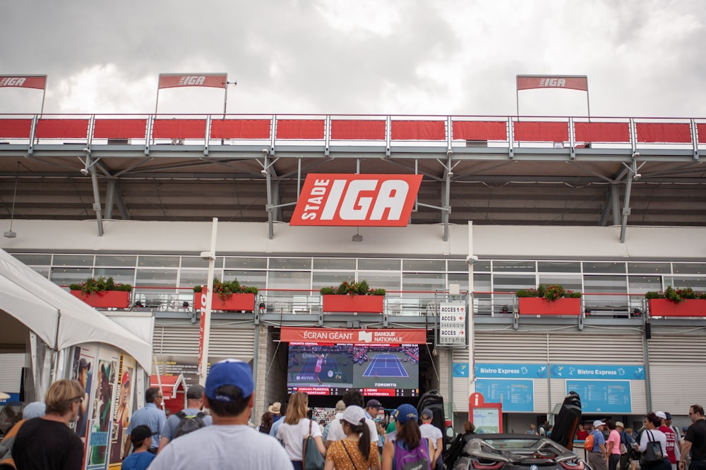 Stade Iga signboard hanging on gray wall