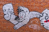 A whimsical street art piece featuring playful characters in motion.