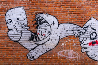 Graffiti art on a sewer wall depicting hopeful faces and abstract dreams.