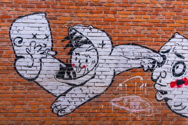 Graffiti art on a sewer wall depicting hopeful faces and abstract dreams.