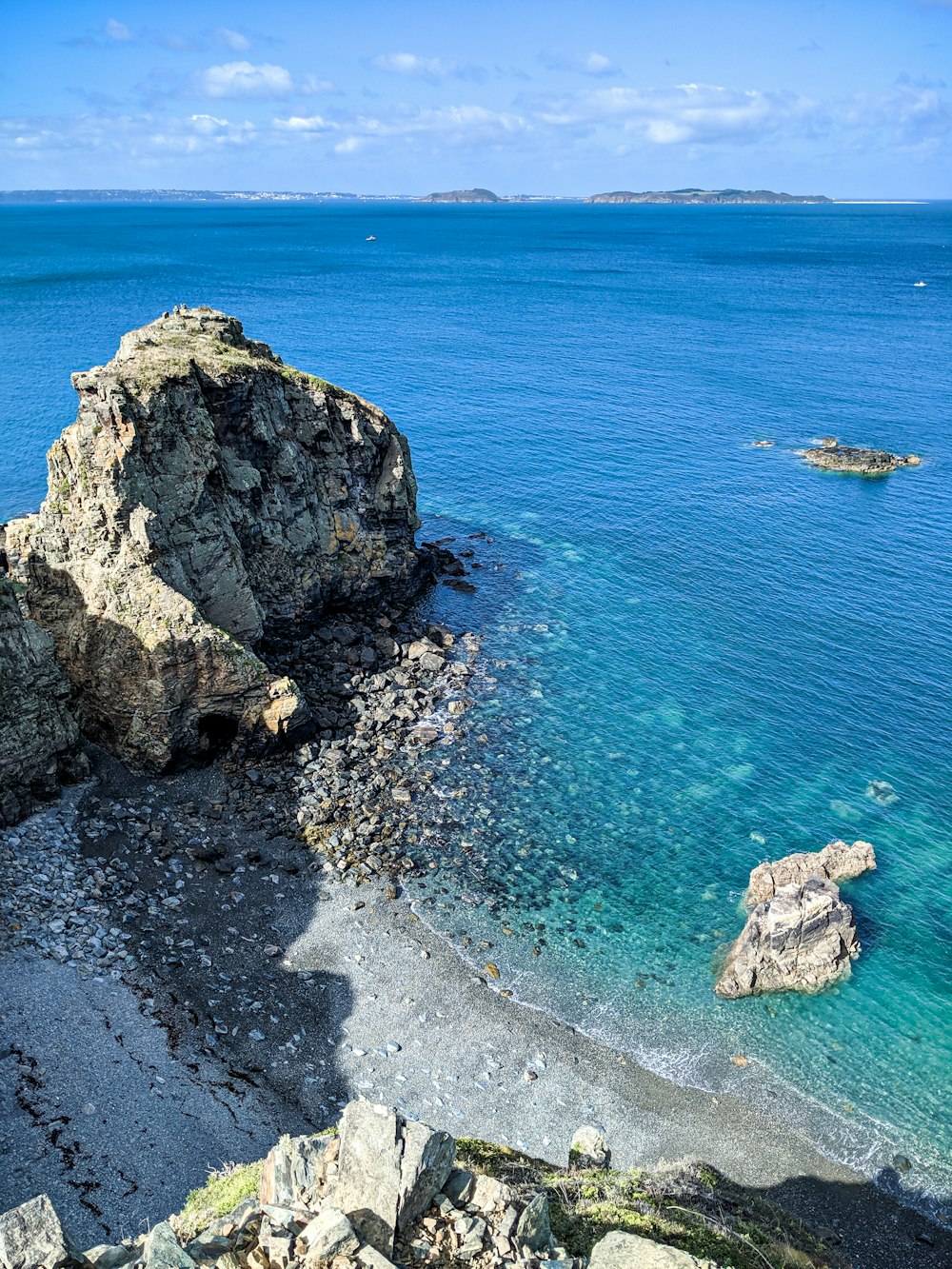 a view of a rocky beach with clear blue water