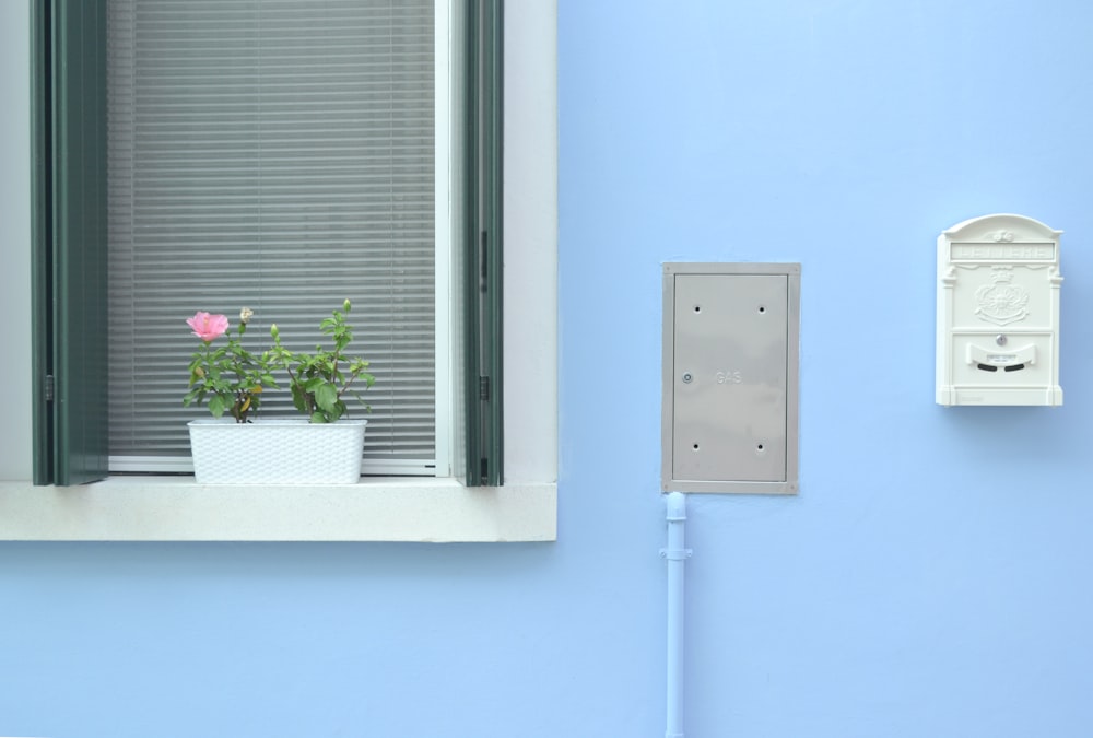 photo of white window blinds and white wooden frames