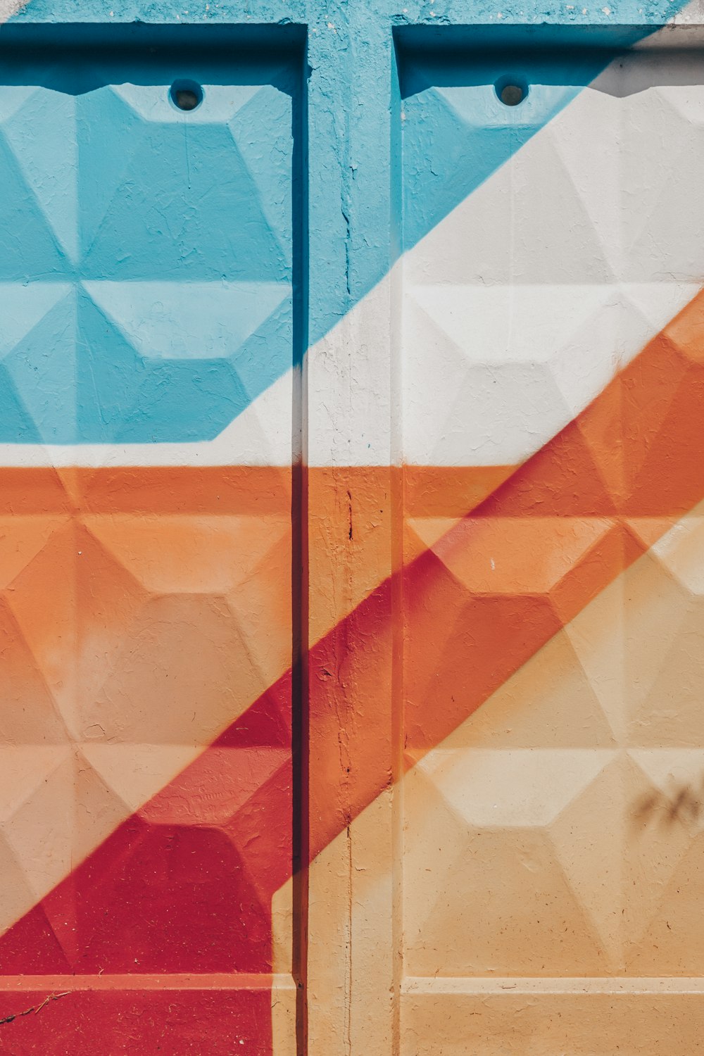 a wall painted with a colorful geometric design