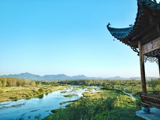 A serene landscape featuring artisans crafting products against a backdrop of nature.